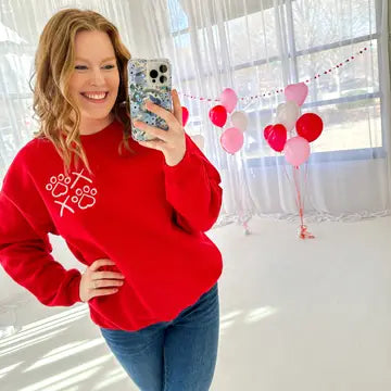 This bright red sweatshirt with X's and Paw's is perfect for a dog moms valentine's day!